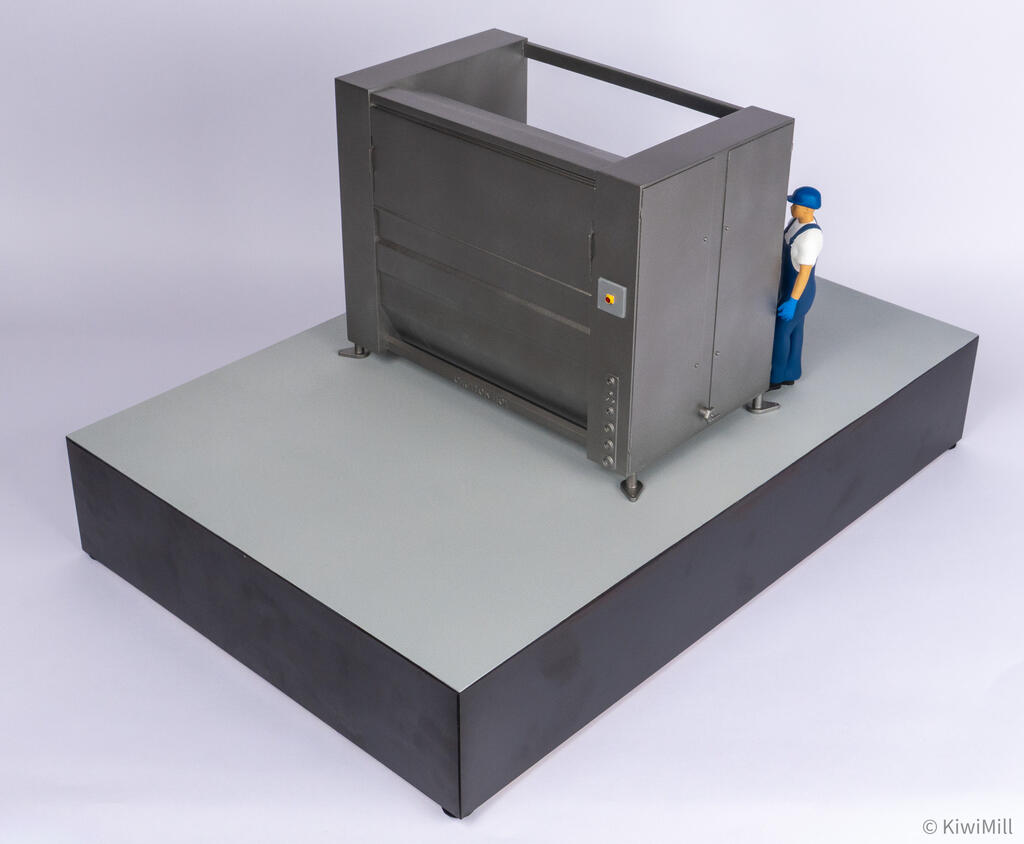 Elevated right rear view of the belt chiller model with the operator figure standing beside the end access doors